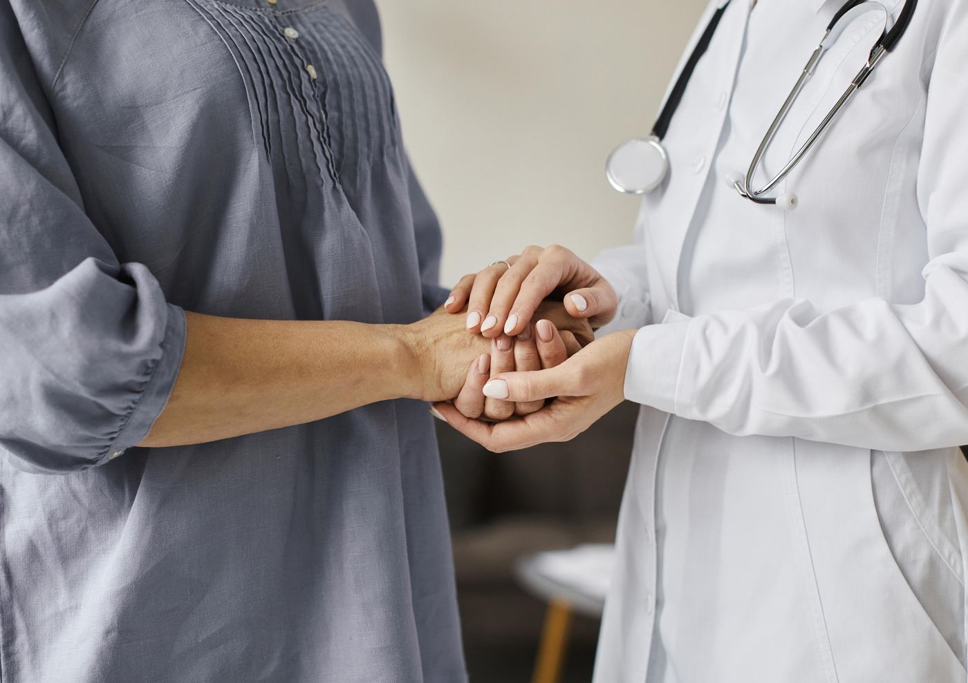 A doctor holding a patient's hands